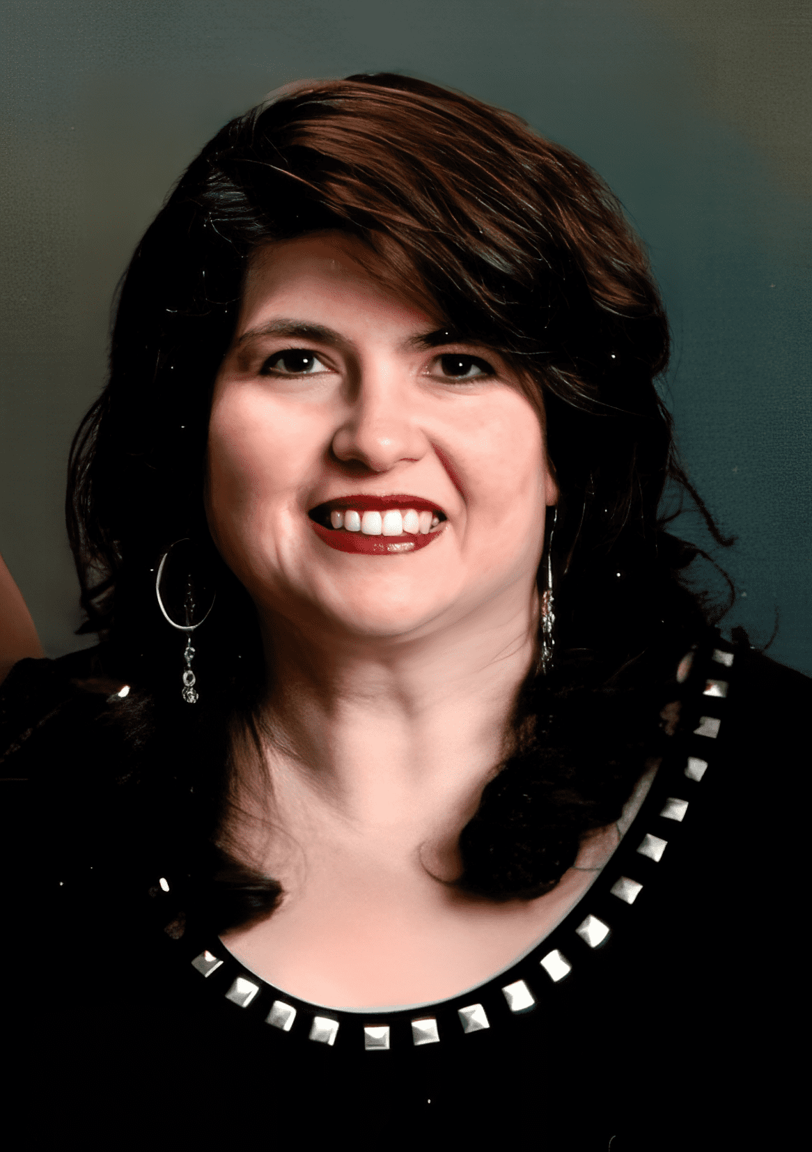 Portrait of a smiling woman with dark hair.