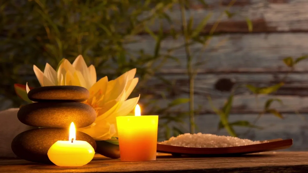 Candles and stones with lotus flower.